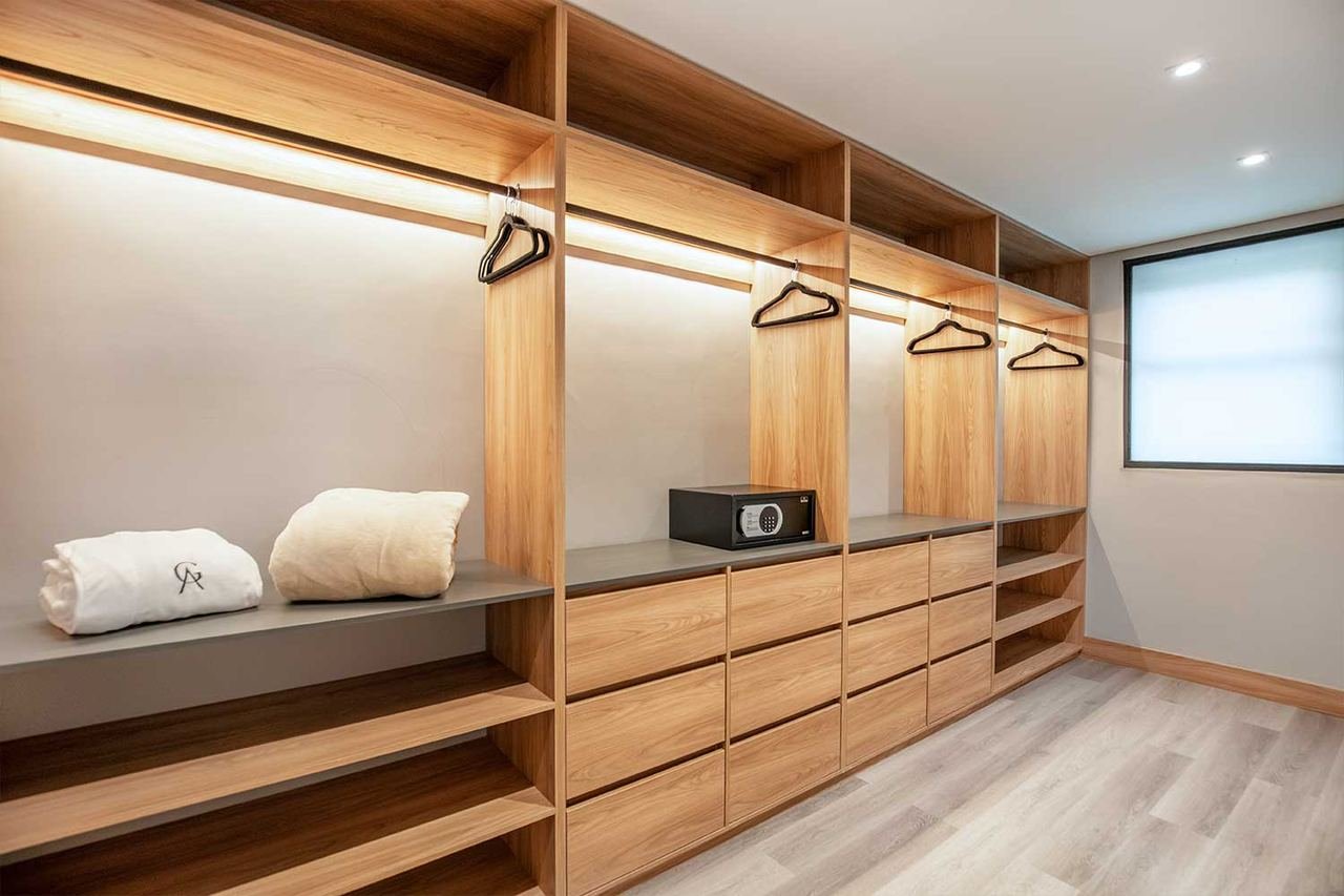 Custom wood walk-in closet with built-in lighting