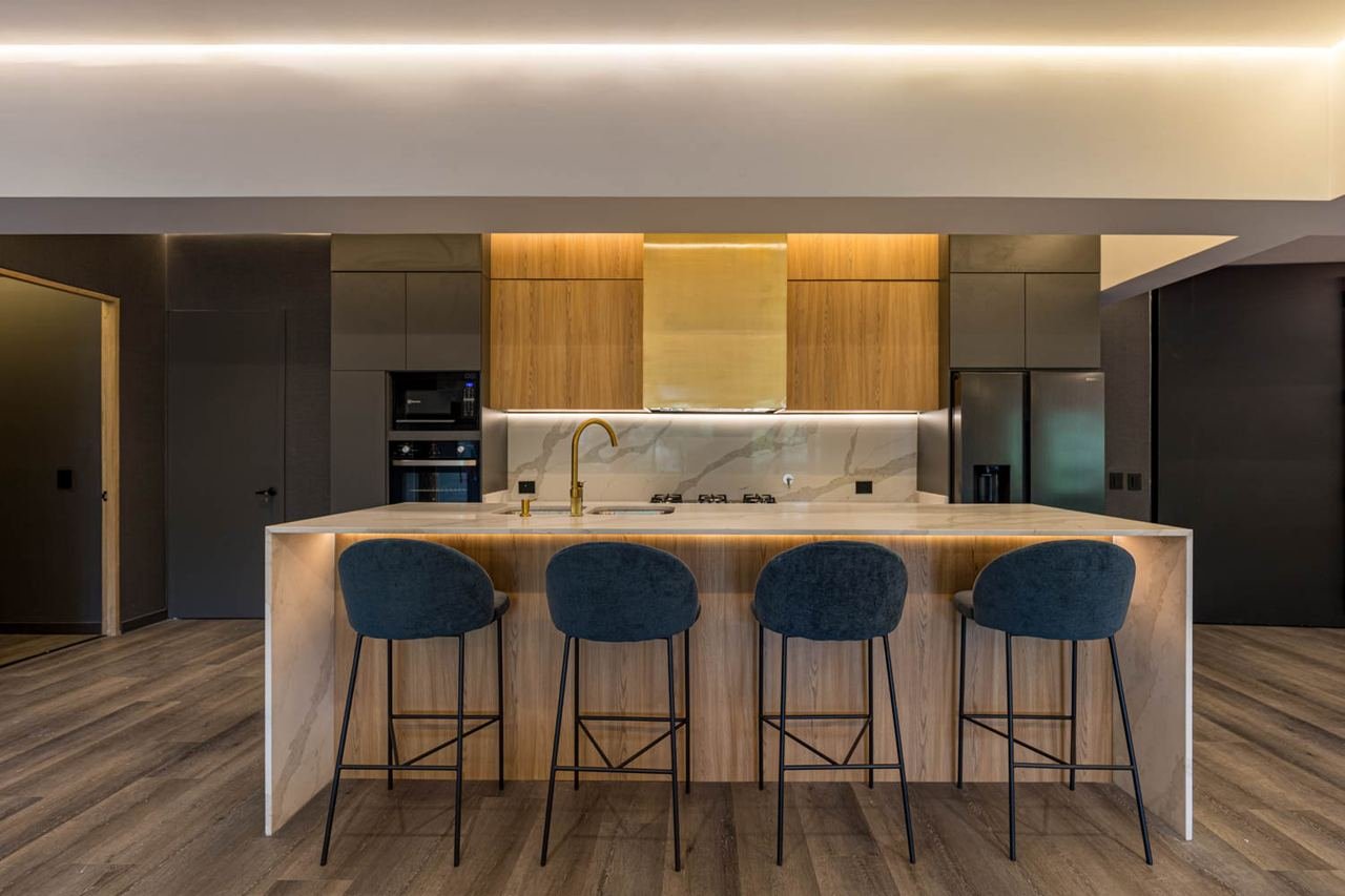 Marble-look kitchen island with bar seating and built-in light