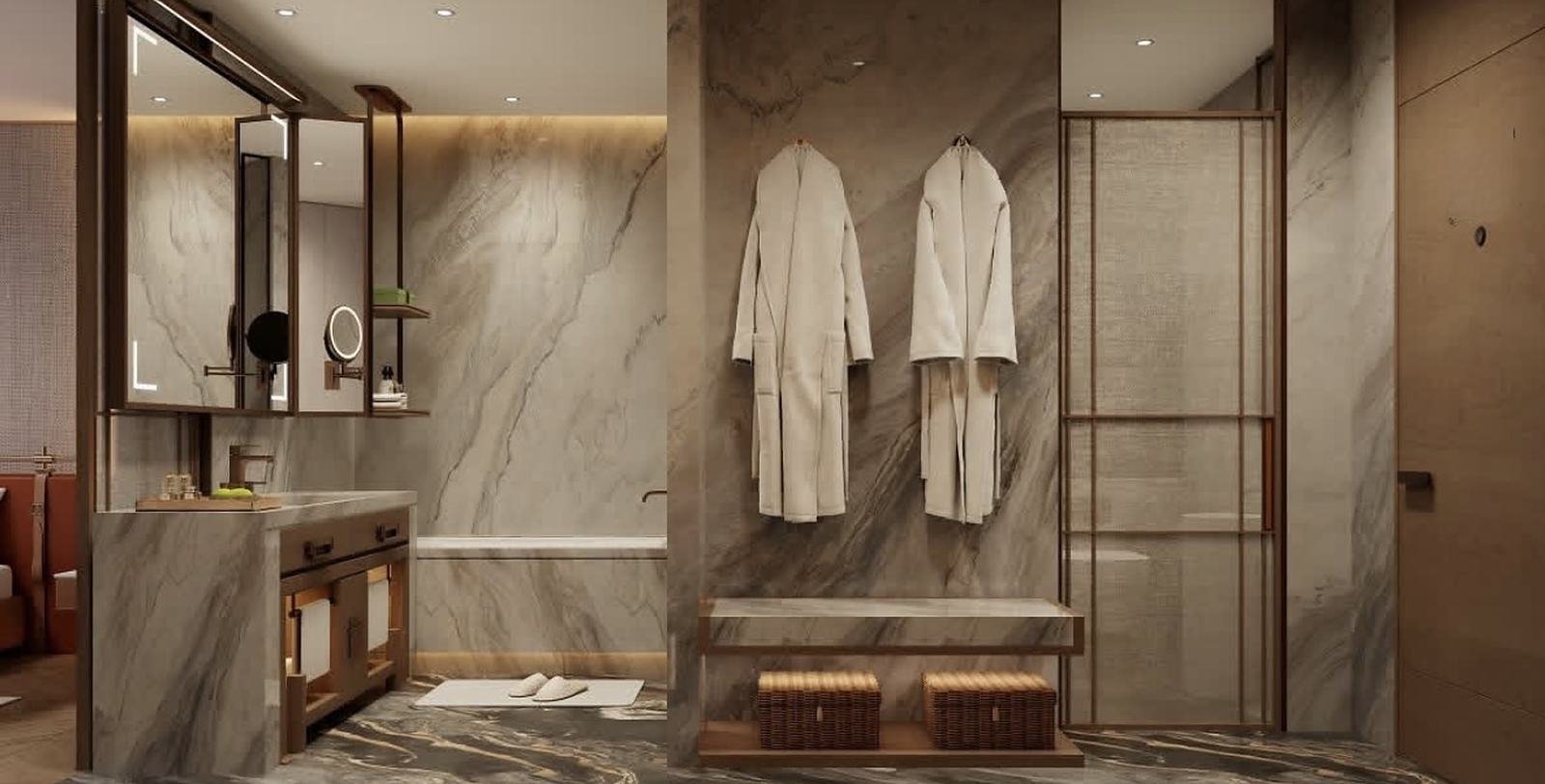 Baño de hotel con muros tipo mármol, mueble de lavamanos, espejo y batas